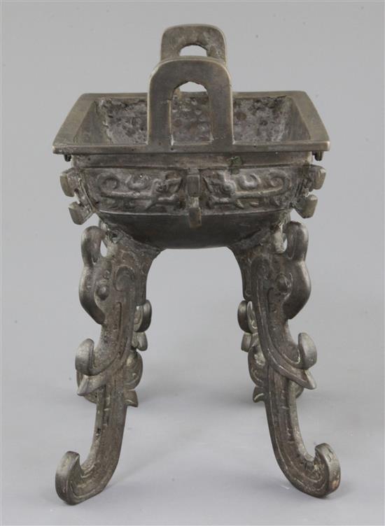 A Chinese archaic bronze quadruped ritual food vessel, Fangding, early Western Zhou dynasty, 22.7cm high, 17.5cm wide, repairs and lack